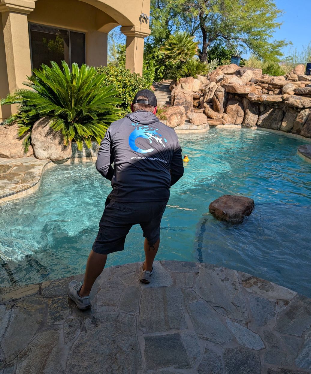 pool technician working on pool with dramatic LED lighting effects