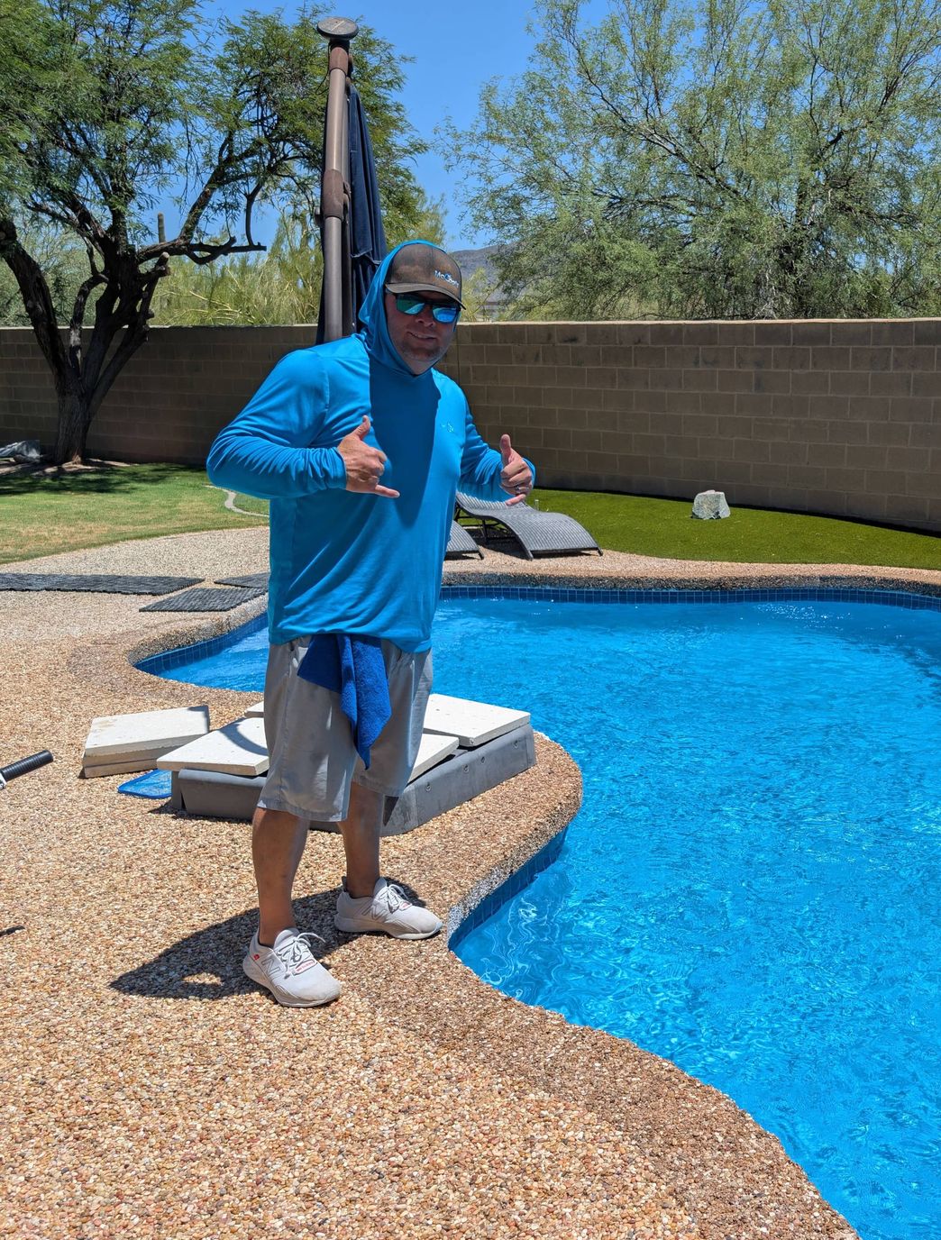 pool technician overlooking Arizona pool